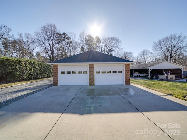 garage featuring a yard and a carport