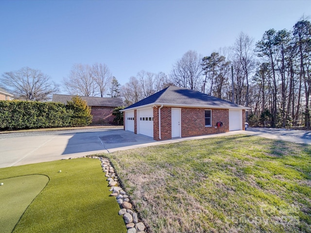 view of side of property with a yard and a garage