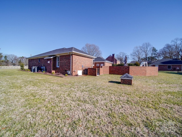 view of property exterior with a yard and an outdoor fire pit