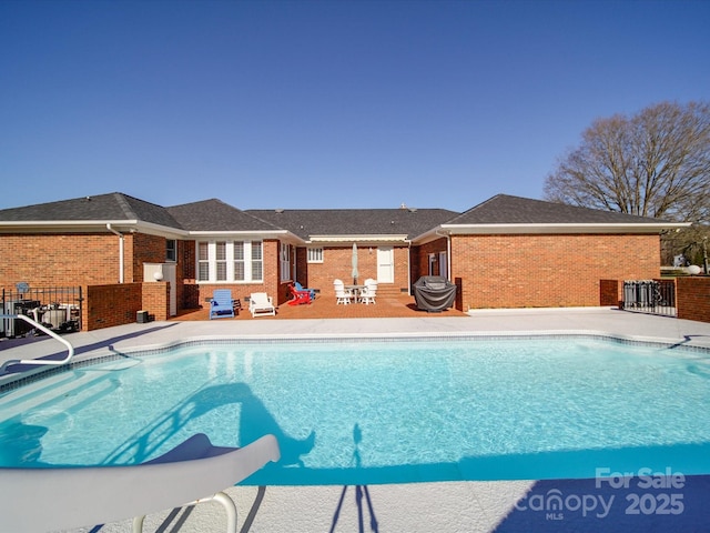 view of swimming pool featuring a patio area