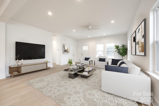 living area featuring ceiling fan, baseboards, light wood-style flooring, and recessed lighting