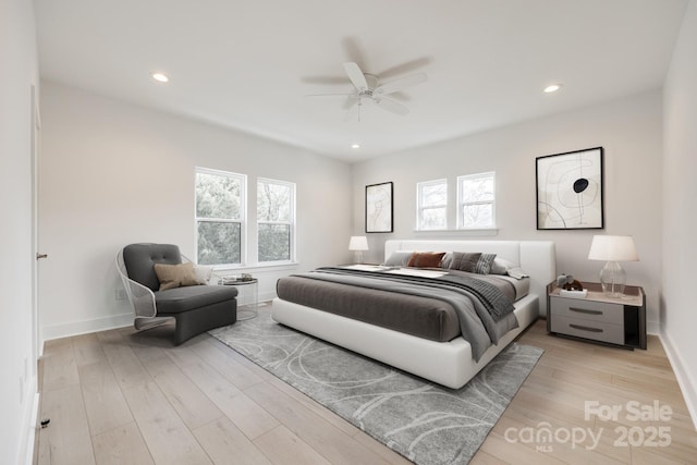 bedroom with light wood-style floors, recessed lighting, and multiple windows