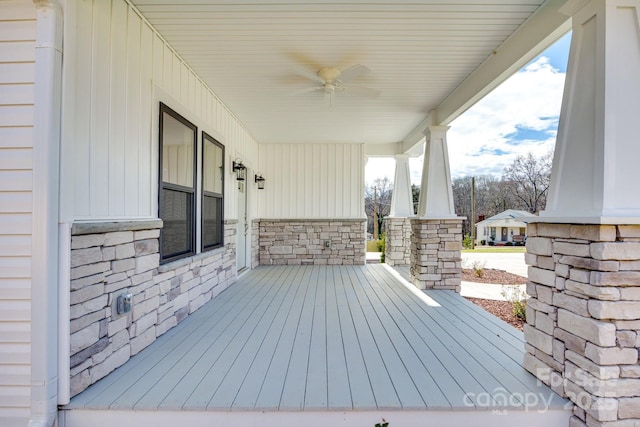 wooden deck with a ceiling fan