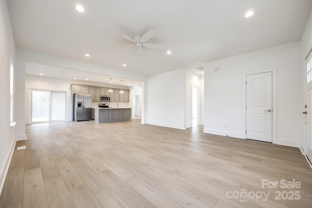 unfurnished living room featuring light wood finished floors, a ceiling fan, and recessed lighting