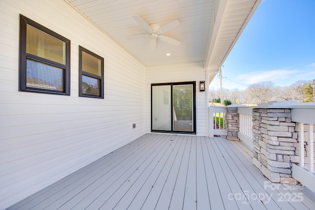 wooden terrace featuring ceiling fan