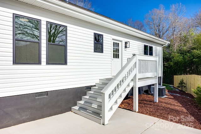 doorway to property with crawl space, a patio area, fence, and central AC