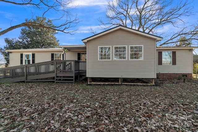 back of house featuring a wooden deck