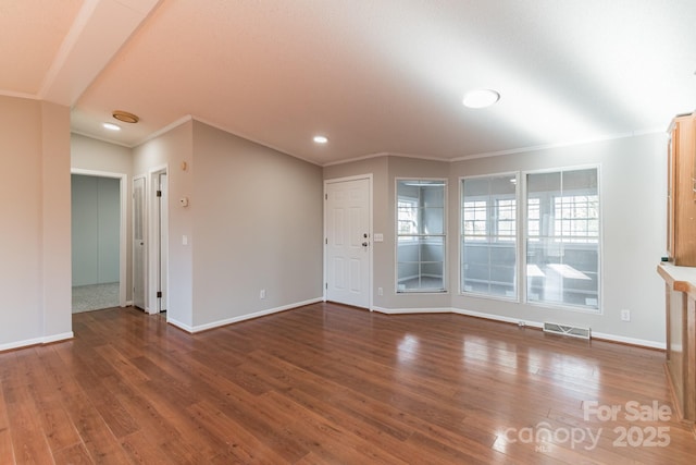 unfurnished living room with crown molding and dark wood-type flooring