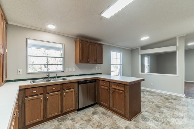 kitchen featuring stainless steel dishwasher, a textured ceiling, sink, and kitchen peninsula