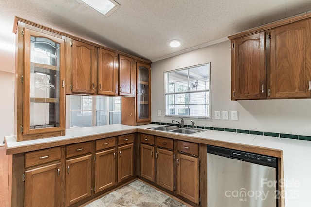 kitchen with ornamental molding, a textured ceiling, dishwasher, and sink