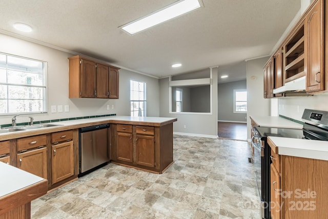 kitchen featuring kitchen peninsula, appliances with stainless steel finishes, ornamental molding, and sink