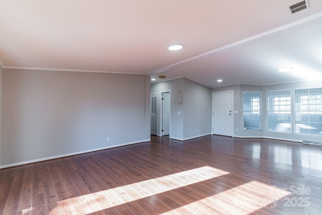 unfurnished living room with crown molding and dark hardwood / wood-style floors