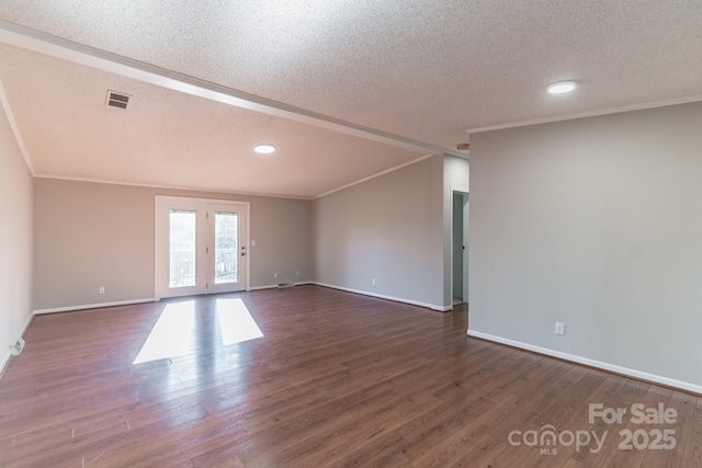 empty room featuring french doors, a textured ceiling, ornamental molding, and dark hardwood / wood-style floors