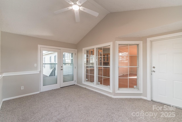 entryway with vaulted ceiling, ceiling fan, french doors, and light carpet