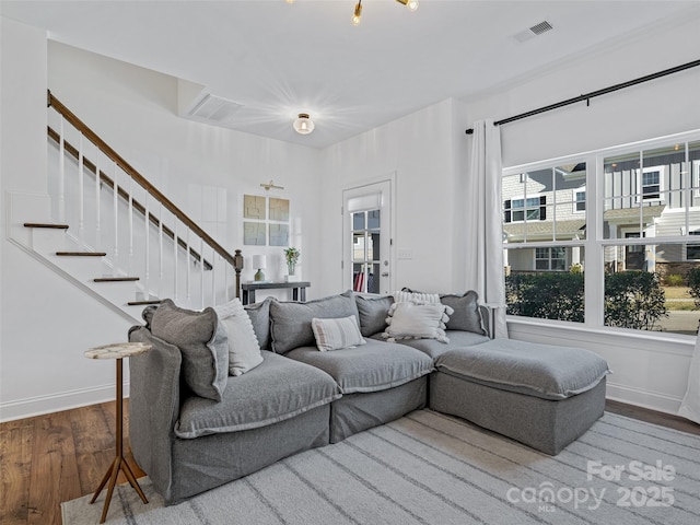 living room with hardwood / wood-style floors and a healthy amount of sunlight