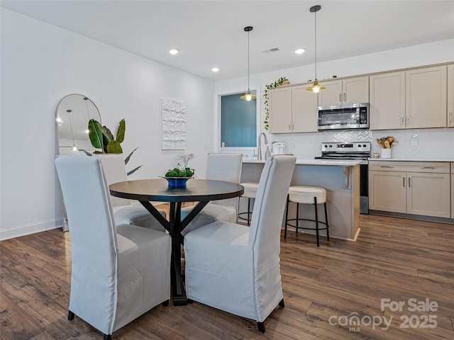 dining area with dark hardwood / wood-style floors