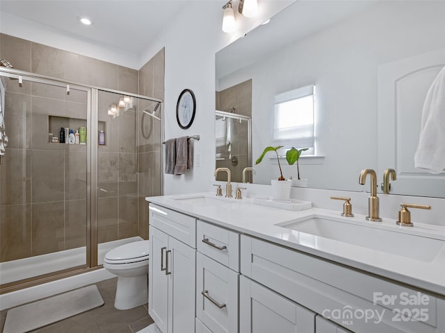 bathroom featuring walk in shower, vanity, tile patterned flooring, and toilet