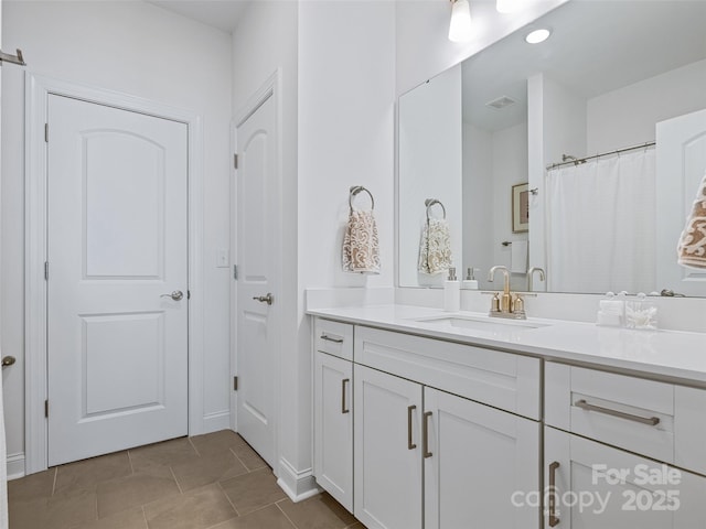 bathroom with tile patterned floors and vanity