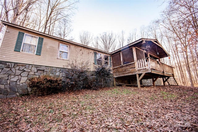 back of house with a deck and a sunroom