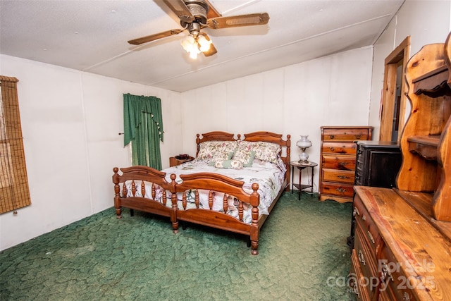 carpeted bedroom with a textured ceiling and ceiling fan