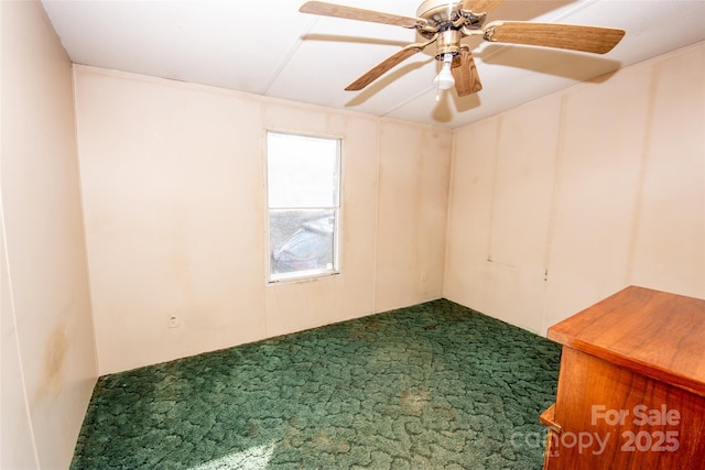 spare room featuring carpet floors and ceiling fan