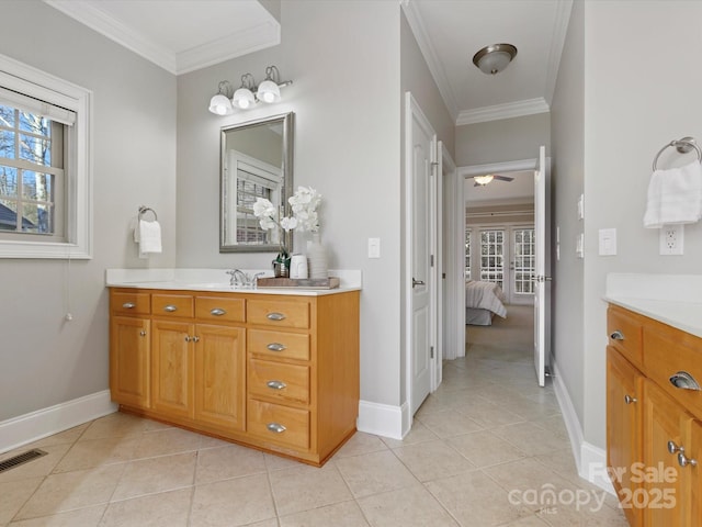 bathroom featuring tile patterned flooring, ornamental molding, and vanity