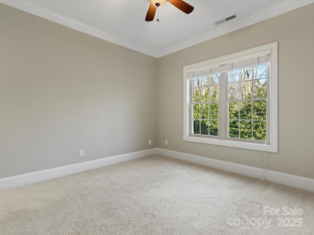 carpeted empty room featuring ceiling fan and ornamental molding