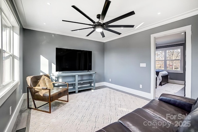 living room with light wood-type flooring, ceiling fan, and ornamental molding