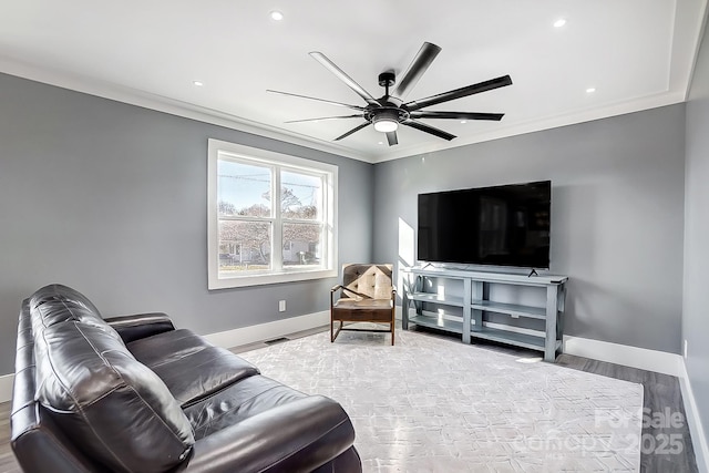 living room featuring ceiling fan, crown molding, and light hardwood / wood-style flooring