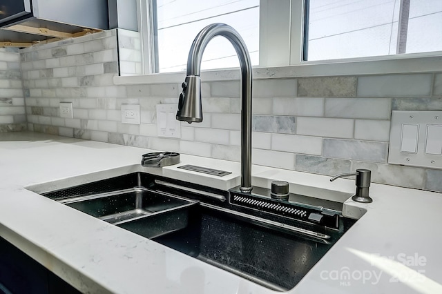 interior details with sink and tasteful backsplash