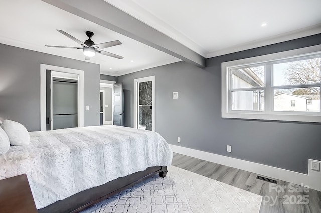 bedroom with ceiling fan, light hardwood / wood-style floors, and crown molding