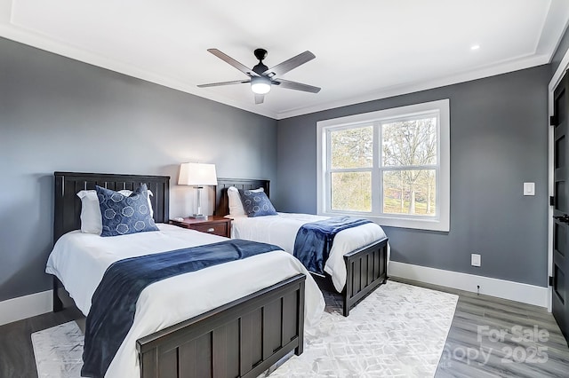 bedroom with ceiling fan, crown molding, and light hardwood / wood-style flooring