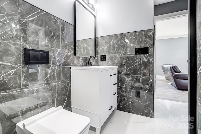 bathroom with tile walls and vanity