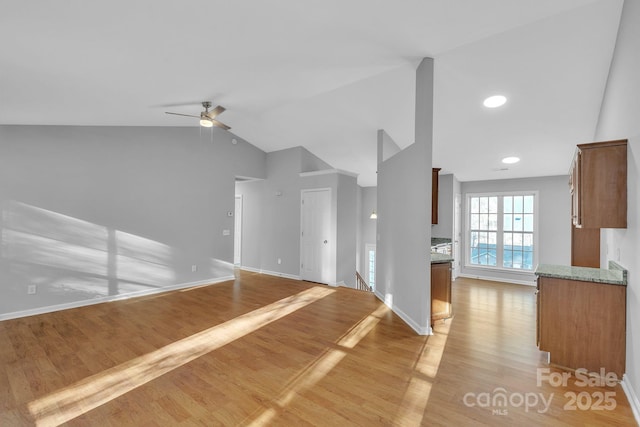 unfurnished living room with lofted ceiling, ceiling fan, and light hardwood / wood-style floors