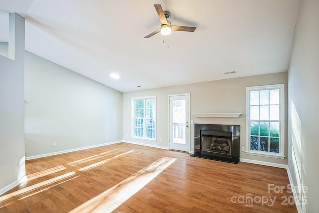 unfurnished living room featuring hardwood / wood-style flooring and ceiling fan