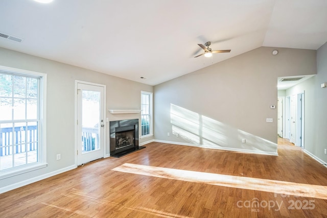 unfurnished living room with ceiling fan, vaulted ceiling, and light hardwood / wood-style flooring