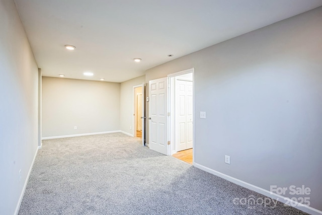 unfurnished room featuring light colored carpet