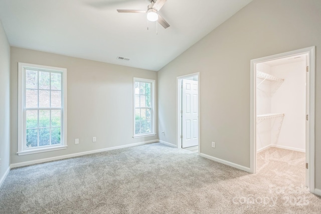 240 Doe Run, Morganton, NC 28655 - unfurnished bedroom with carpet flooring, a walk in closet, lofted ceiling, baseboards, and visible vents