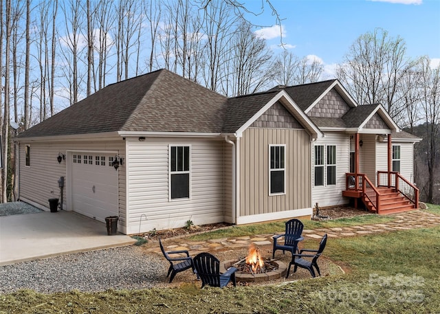 view of front of house featuring a garage and an outdoor fire pit