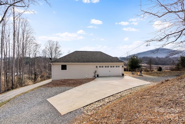 view of home's exterior featuring a garage and a mountain view