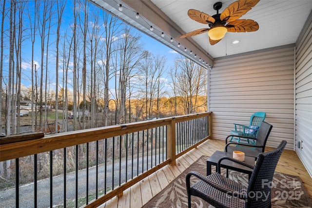 wooden balcony with ceiling fan and a deck