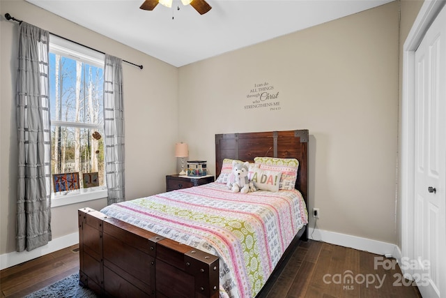 bedroom featuring ceiling fan, a closet, and dark hardwood / wood-style flooring