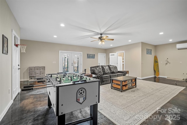 rec room featuring an AC wall unit, ceiling fan, and french doors