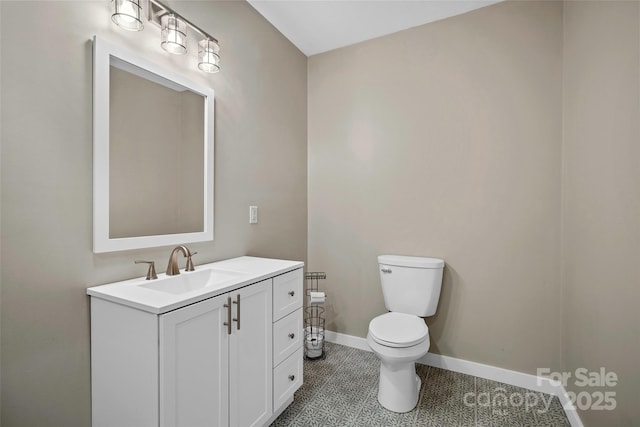 bathroom featuring toilet, tile patterned floors, and vanity