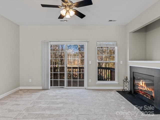 unfurnished living room with light carpet and ceiling fan