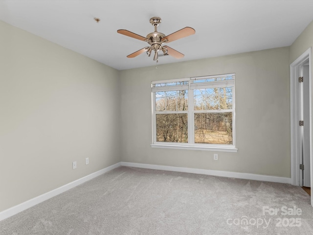 spare room with carpet floors and ceiling fan