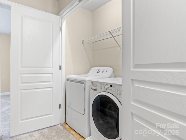 laundry room featuring light carpet and washing machine and clothes dryer