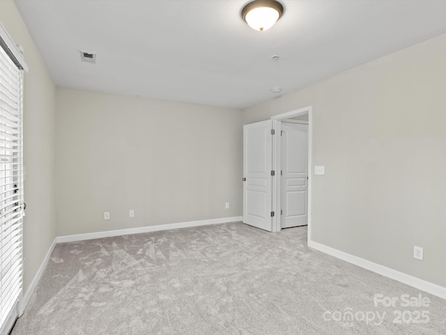 unfurnished bedroom featuring light carpet