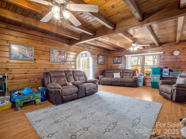 living room with wood ceiling, wooden walls, and light hardwood / wood-style floors