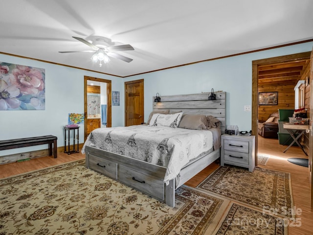 bedroom with hardwood / wood-style flooring, ornamental molding, and ceiling fan